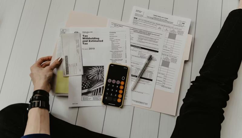 Person reviewing household budget at kitchen table
